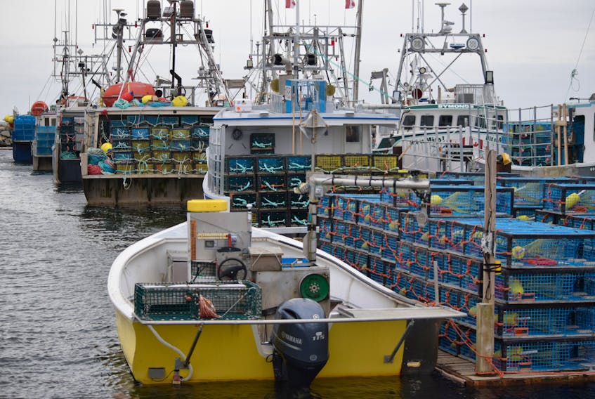 Fishing boats loaded with lobster traps lay berthed at one of the floating docks at the Falls Point wharf in Woods Harbour, waiting for the LFA 34 lobster fishery to open. KATHY JOHNSON