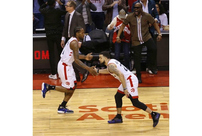 Raptors' Kawhi Leonard (left) shakes hands with Fred VanVleet during the third quarter in Toronto, Ont. on Sunday, May 12, 2019.