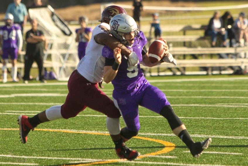Bishop's Gaiters quarterback Justin Quirion is tackled by the Mount Allison Mounties during the AUFC semifinal Saturday in Lennoxville, Que. The Mounties won 15-12 to advance to the Loney Bowl next Saturday at St. Francis Xavier. - HANNAH McCARTHY / BISHOP'S ATHLETICS