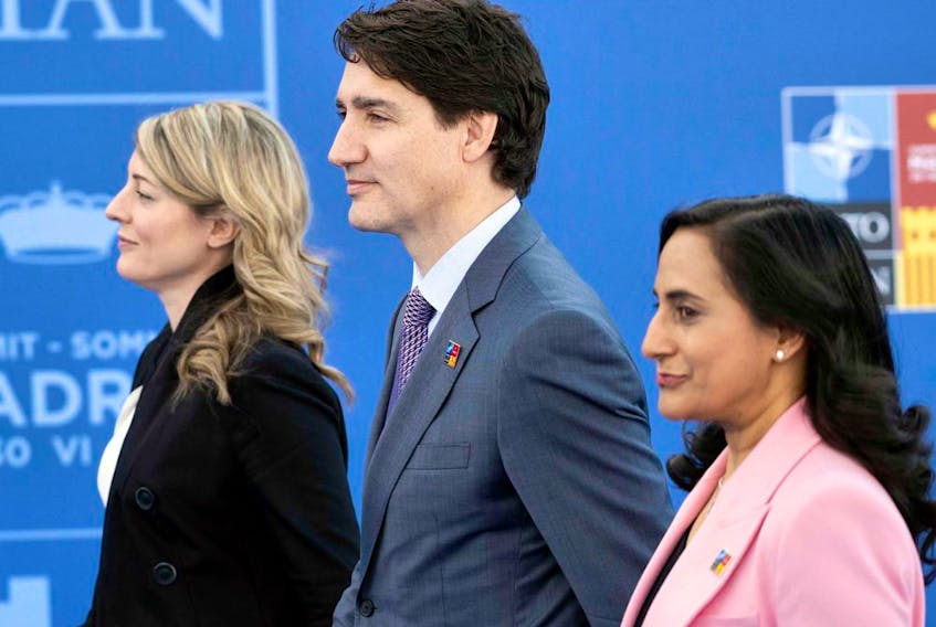 From left, Foreign Affairs Minister Mélanie Joly, Prime Minister Justin Trudeau and Defence Minister Anita Anand received a report from a parliamentary committee four months ago that raised alarms about irregularities.