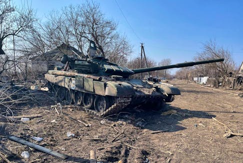 A disabled Russian tank sits next to a road in Kyiv in April. According to U.S. and UK intelligence sources, Russia has lost over 2,000 main battle tanks in the first eight months of combat.  - Reuters