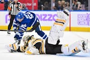 Boston Bruins goalie Linus Ullmark dives to reach a loose puck ahead of Maple Leafs' Michael Bunting in the second period at Scotiabank Arena on Saturday, Nov. 5, 2022. 