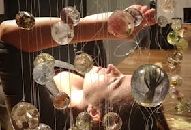 Philippa Jones is the ArtsNL 2021 Artist of the Year, which she was rewarded in 2022. Here she is pictured at one of her installations, featuring thousands of suspended resin orbs with organic matter cast inside. Contributed photo.