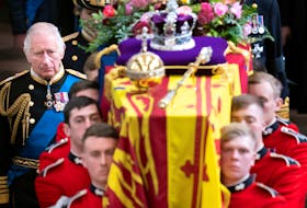 King Charles III and members of the royal family follow the coffin of Queen Elizabeth II, draped in the Royal Standard with the Imperial State Crown and the Sovereign's orb and sceptre, as it is carried out of Westminster Abbey on Monday, Sept. 19. - Reuters