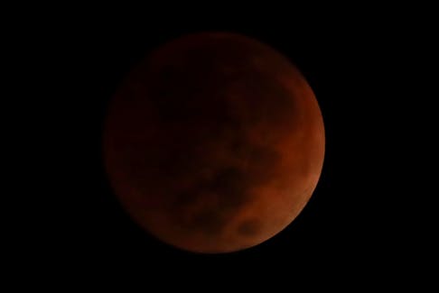 The moon takes on a blood-red cast during a total lunar eclipse in Mexico City, Mexico, on Tuesday, Nov. 8, 2022. - Henry Romero / Reuters