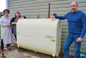 From left, Trish Landry, Helen Mortimer and Joe Gamble stand by the oil tank at Health Park Early Learning Centre in Sydney on Wednesday. There is now a blue lock on the cap of the tank after thieves drained more than $2,000 of furnace oil from it. NICOLE SULLIVAN/CAPE BRETON POST