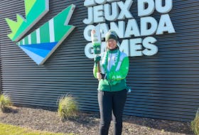 SaltWire Network's Alison Jenkins hoists the flame at the Canada Games Torch Relay in Summerside Nov. 8. Contributed.