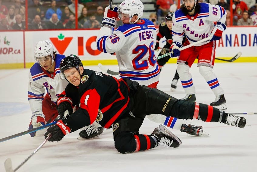 Ottawa Senators left wing Brady Tkachuk (7) and New York Rangers defenceman Braden Schneider battle during first-period NHL action at the Canadian Tire Centre on Wednesday, Nov. 30, 2022.