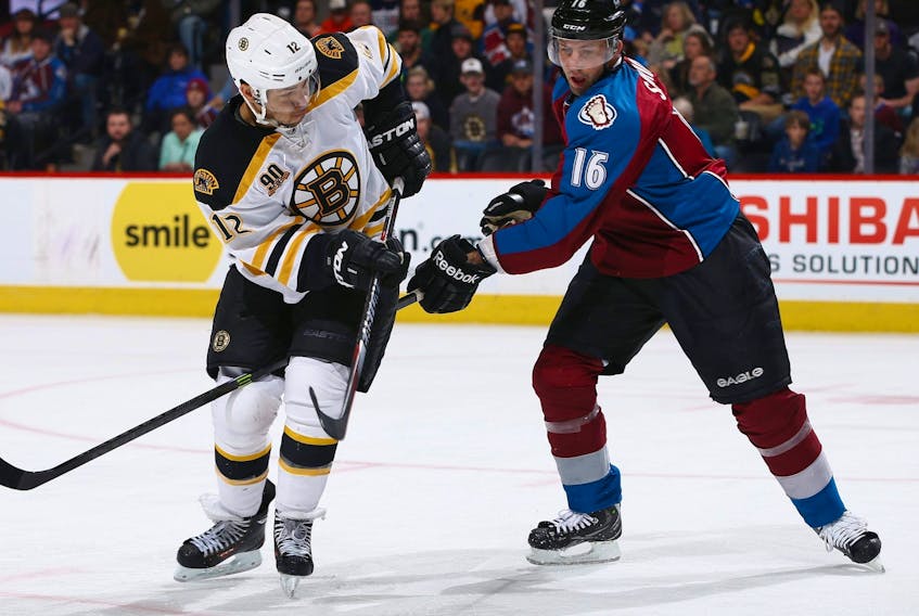 Cory Sarich of the Colorado Avalanche defends against Jarome Iginla of the Boston Bruins at Pepsi Center on March 21, 2014 in Denver, Colorado.  