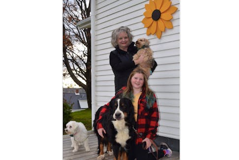 Bernadette (Bernie) McKeigan-Withers and her granddaughter Lailee Head are shown with Molly the Bernese Mountain dog, plus Riley, left, and Ralphie, being held by Bernie. They are donating to the SPCA in honour of Bernie’s son and Lailee’s father, the late Jeff Head.