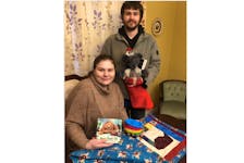 Kayla Meade and Elijah Grosvold, whose son was stillborn, are filling a Christmas stocking for another child in their son’s memory. In the foreground is a small quilt they received from the palliative care unit at Aberdeen Hospital.