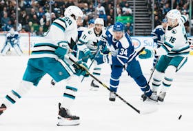 Maple Leafs' Auston Matthews tries to bring the puck through the San Jose Sharks defence during the second period in Toronto on Wednesday, Nov. 30, 2022.