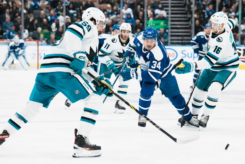 Maple Leafs' Auston Matthews tries to bring the puck through the San Jose Sharks defence during the second period in Toronto on Wednesday, Nov. 30, 2022.