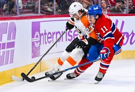 Montreal Canadiens right wing Brendan Gallagher battles Philadelphia Flyers centre Lukas Sedlak near the boards during the second period at the Bell Centre in Montreal on Nov. 19, 2022.