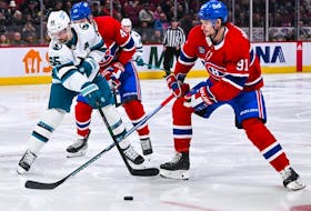 San Jose Sharks defenceman Erik Karlsson battles for the puck with Montreal Canadiens centre Sean Monahan (91) during the second period at Bell Centre in Montreal on Nov. 29, 2022.