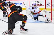 Flames forward Andrew Mangiapane scores on Sergei Bobrovsky in the third period of Tuesday's game against the Florida Panthers.