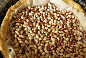 The crust for quiche is blind-baked – baked before the filling is added. Before blind baking, line the unbaked pie shell with either pie weights or about 500 g (1 lb) of dried beans to prevent the crust from buckling. Contributed