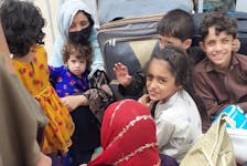 Members of the Afghan family being sponsored by the Canadian Afghan Rescue Effort (CARE) committee in Shelburne ride in the back of a truck while fleeing flood conditions in Pakistan, where they are waiting to come to Canada. CONTRIBUTED