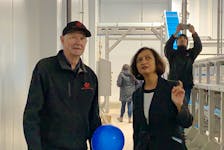 Former owner of GM Newell Ltd, now Atlantic ChiCan, Paul Newell, talks with Wahyu Raharjo, quality control manager for Atlantic ChiCan, during a tour of the new lobster processing plant in Clark’s Harbour. KATHY JOHNSON