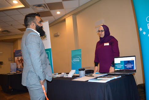 Ankit Wadhwa, left, chats with Ayha El-Darahali from the Cape Breton Partnership prior to the start of the Cape Breton Local Immigration Partnership third annual partner update at the Membertou Trade and Convention Centre. Wadhwa spoke about the importance of building social networks during the session. GREG MCNEIL/CAPE BRETON POST