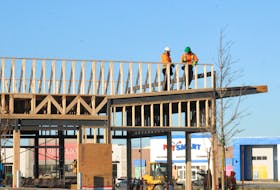 Construction workers were busy on the roof of a new medical building under construction in the Shoppes at Galway retail area on Wednesday afternoon, Nov. 30. Joe Gibbons • The Telegram
