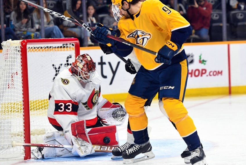 Senators goaltender Cam Talbot makes a save as Predators winger Filip Forsberg crosses in front of the net during the first period of Saturday's game in Nashville.