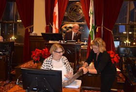 Donna Waddell, left, interim chief administrative officer with the City of Charlottetown, talks with Sue Fraser, a director with the city, as Mayor Philip Brown prepares for the regular public monthly meeting on Dec. 12. Dave Stewart • The Guardian