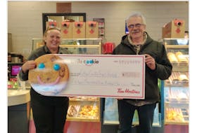 Pictou County Fuel Fund chairperson George MacLellan (right) is shown accepting a donation of $15,506 from Tanja MacEachern, manager of the Tim Horton’s on Westville Road. The funds were raised from the annual Smile Cookie Campaign.