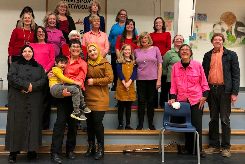 The Hantsport Community Choir posed with Nahed Osman, her mother Suaad Rustum and young son at a recent fundraising concert.