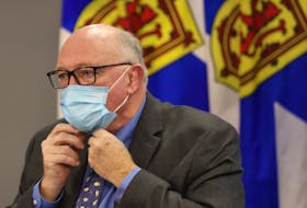 Dr Robert Strang puts on his mask following a news conference in Halifax Friday December 16, 2022

TIM KROCHAK PHOTO