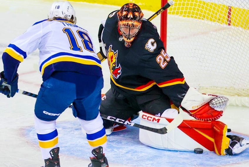  Calgary Flames goaltender Jacob Markstrom gets a pad on this shot by St. Louis Blues forward Robert Thomas at the Scotiabank Saddledome in Calgary on Friday, Dec. 16, 2022.