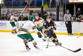Charlottetown Islanders forward Owen Hollingsworth, 21, carries the puck into the offensive zone against Halifax Mooseheads defenceman Brady Schultz, 5, in a Quebec Major Junior Hockey League (QMJHL) game at Eastlink Centre on Dec. 17. The Mooseheads won the game 7-2. Charlottetown Islanders Photo • Special to The Guardian