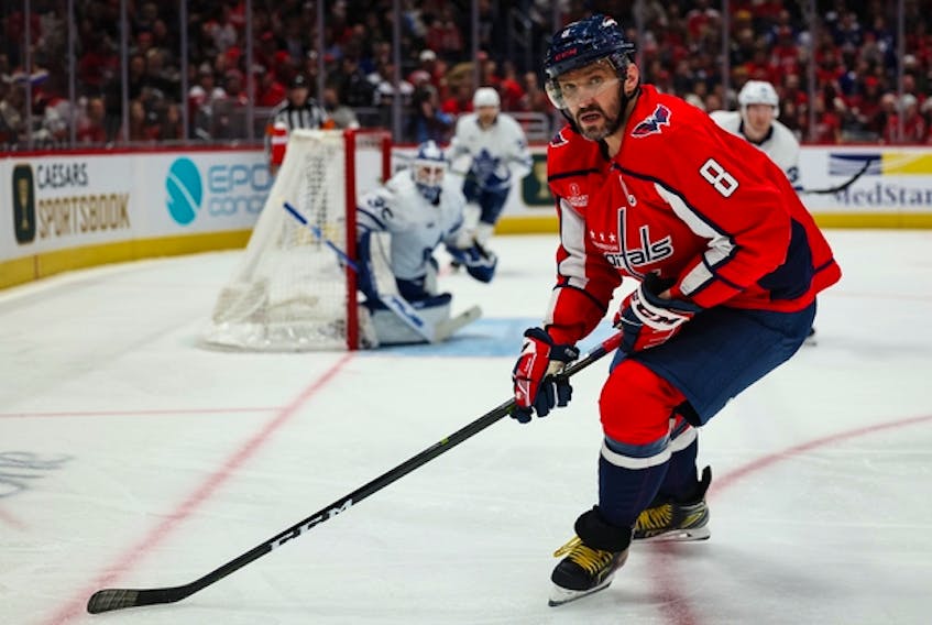 Washington Capitals captain Alex Ovechkin goes after a puck in the corner at Capital One Arena on Saturday night. The Maple Leafs kept Ovechkin off the scoresheet and away from Gordie Howe's goal mark for at least another night.