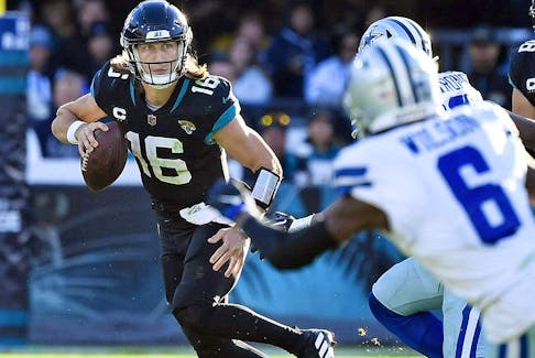 Jacksonville Jaguars quarterback Trevor Lawrence scrambles during the game against the Dallas Cowboys at TIAA Bank Field.  