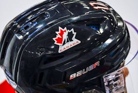 A Hockey Canada logo is visible on the helmet of a national junior team player during a training camp practice in Calgary, Tuesday, Aug. 2, 2022.