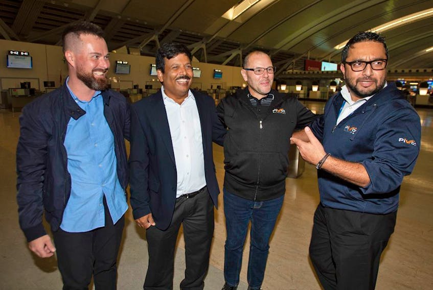  Pivot Airlines employees, left to right, Alexander Rozov, Bal Krishna Dubey, Cpt. Robert DiVenanzo and Aatif Safdar laugh after their arrival back to Canada at Toronto Pearson International Airport, Thursday December 1, 2022.