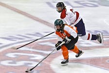 Cape Breton Capers captain Leah Byrne skates the puck into the offensive zone during Atlantic Collegiate Hockey Association action against the Acadia Axewomen in Wolfville last month. The Capers will host the Holland College Hurricanes of Charlottetown in their home opener this weekend in Membertou. CONTRIBUTED/GARY MANNING