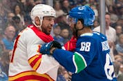  Milan Lucic and Vancouver Canucks forward Vincent Arseneau get acquainted during a pre-season game on Sept. 25.