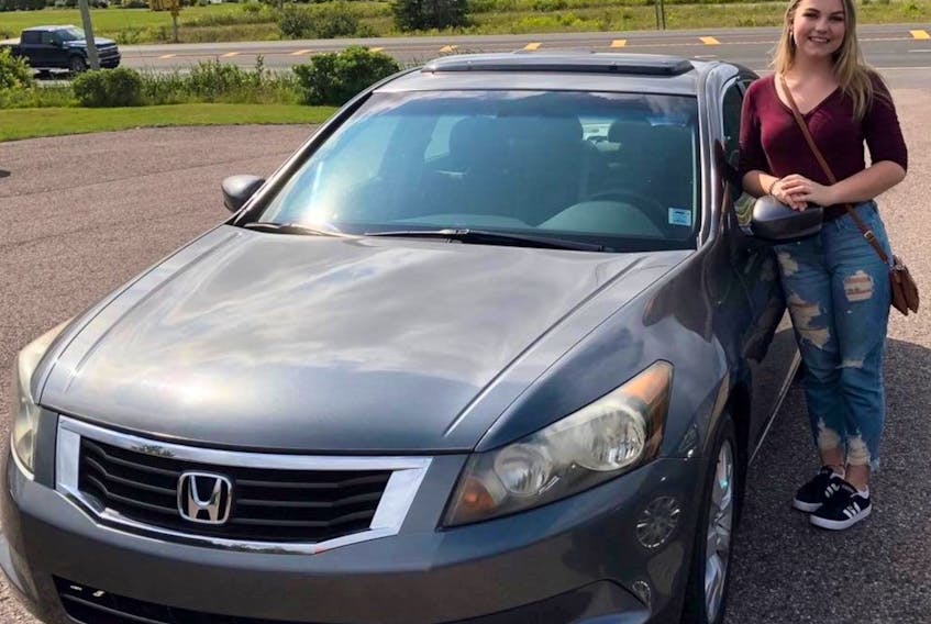 Chloe Richards of Sydney Forks wth her beloved Honda Accord Marvin in better times — before the car was struck in a hit and run. Contributed