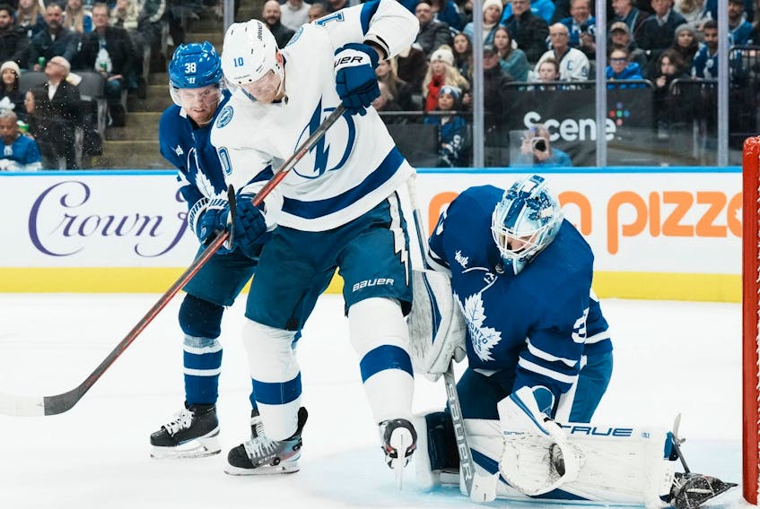 Toronto Maple Leafs' Matt Murray makes a save as Tampa Bay Lightning's Corey Perry and Maple Leafs' Rasmus Sandin battle in front during first period NHL hockey action in Toronto, on Tuesday, December 20, 2022.