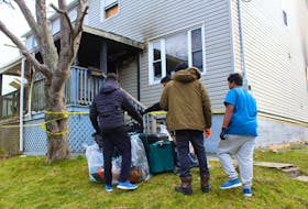 Students displaced by a fire at their rental unit on Dec. 17 remove some belongings from the semi-detached home on Dec. 22. They are still unable to get into all of the rooms in the home due to the fire and are unsure of what can be salvaged as there was heavy smoke throughout the home. NICOLE SULLIVAN/CAPE BRETON POST