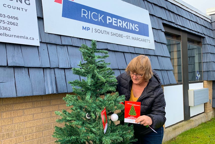 Mandy Symonds decorates a Christmas tree with ornaments representing the EI black hole and postcards to Prime Minster Justin Trudeau. “The black hole is not a gift. Action must take shape,” reads the card. For seasonal workers, the EI black hole is when benefits have run out and there is no work to generate income, which can be three to four months a year. KATHY JOHNSON