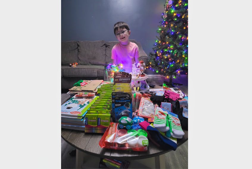 Badger’s Bentley Saunders was proud as he purchased gifts he fundraised to buy in the hopes of making children happy this holiday season. He picked them out himself and happily pushed the cart the whole time. CONTRIBUTED