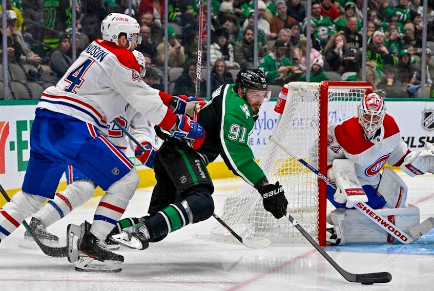 Canadiens' Joel Edmundson (44) checks Dallas Stars' Tyler Seguin (91) as goaltender Jake Allen defends the net during the second period at the American Airlines Center on Friday, Dec. 23, 2022, in Dallas. 