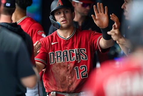Daulton Varsho of the Arizona Diamondbacks celebrates in the dugout after a second inning run scored against the Colorado Rockies at Coors Field on July 3, 2022 in Denver, Colorado.  
