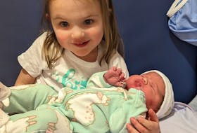 Sage Gallant holds her little sister, Avry, born Dec. 25, at the Prince County Hospital in Summerside. Contributed