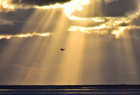 A search and rescue helicopter is photographed on Monday, Dec. 26, as the search for a missing lobster fisherman was being conducted from the air and on the sea. KATHY JOHNSON PHOTO