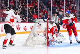 Canadian forward Adam Fantilli, left, attempts to score a 'Michigan' goal against Czechia during an IIHF World Junior Hockey Championship game at the Scotiabank Centre on Monday. - IIHF