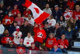 A Team Canada fan flies the Maple Leaf during Monday's IIHF world junior championship opener between Canada and Czechia at Scotiabank Centre. - RYAN TAPLIN / THE CHRONICLE HERALD