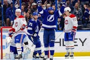 Alex Killorn #17 of the Tampa Bay Lightning celebrates his goal as Christian Dvorak #28 and Arber Xhekaj #72 of the Montreal Canadiens react during the first period at the Amalie Arena on December 28, 2022 in Tampa, Florida.